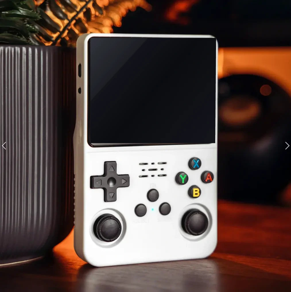 Elinose retro handheld game console in Arctic White on a wooden table, screen off